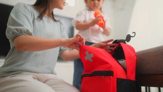 mother and child packing emergency bag